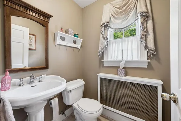 a bathroom with a sink a toilet and a mirror