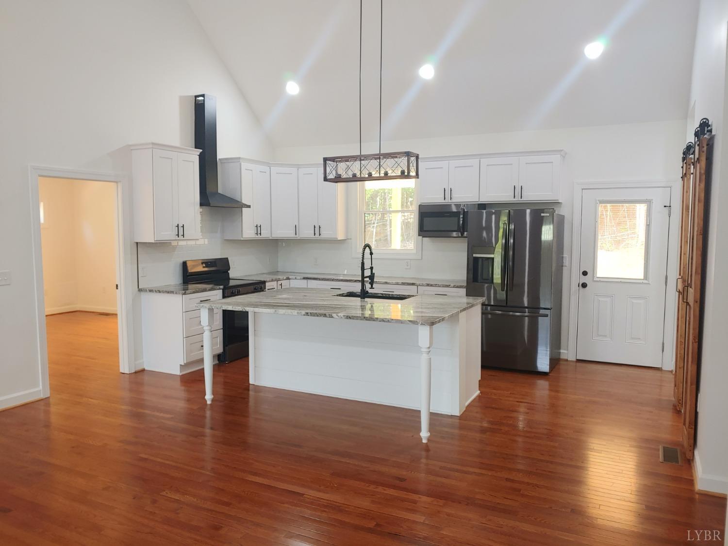 6230 Charlemont Road Goode, VA 24556 - Photo 23 of 99 a kitchen with stainless steel appliances a refrigerator sink and cabinets