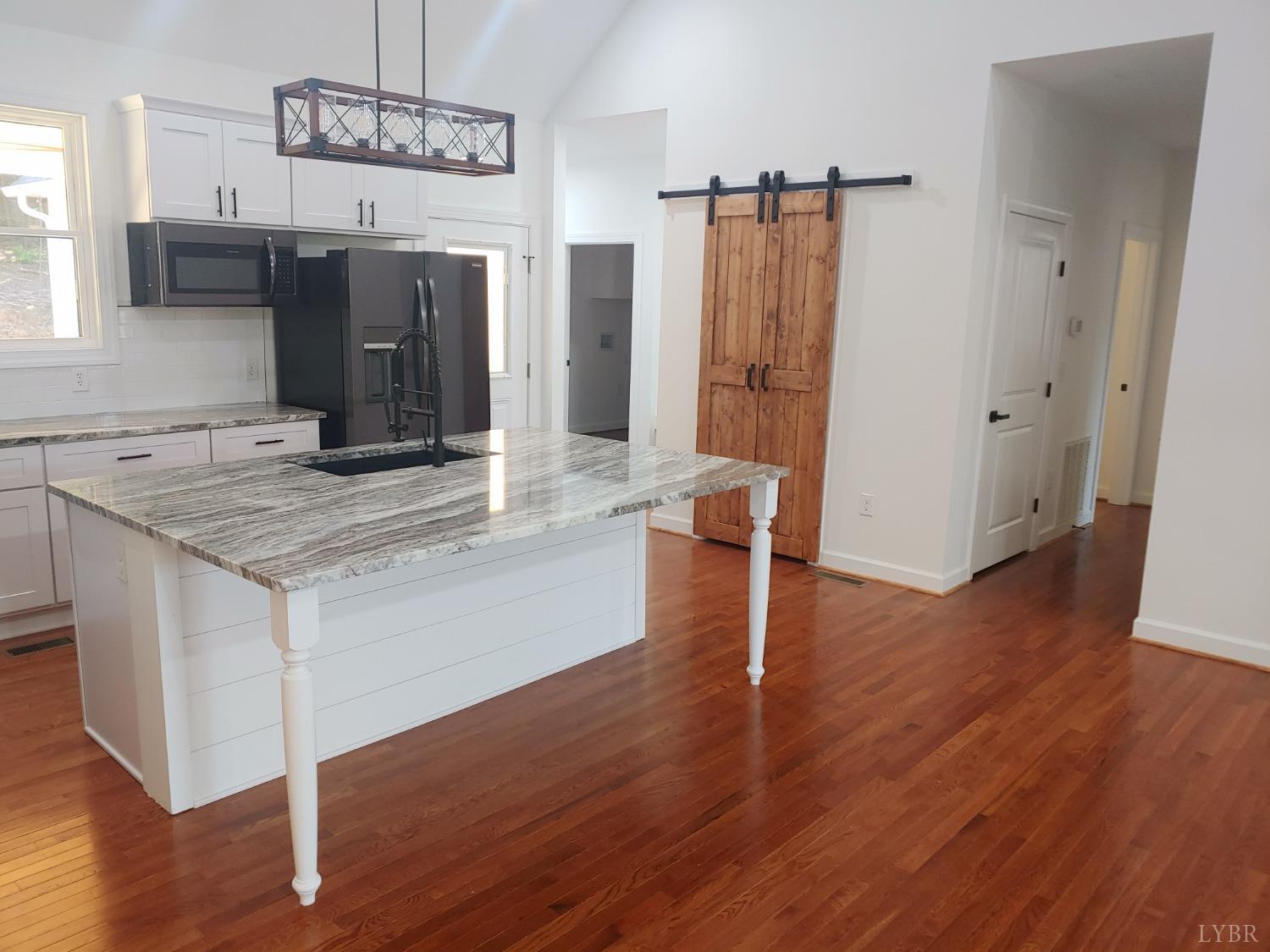 6230 Charlemont Road Goode, VA 24556 - Photo 26 of 99 a kitchen with stainless steel appliances granite countertop a refrigerator a stove and a wooden floors