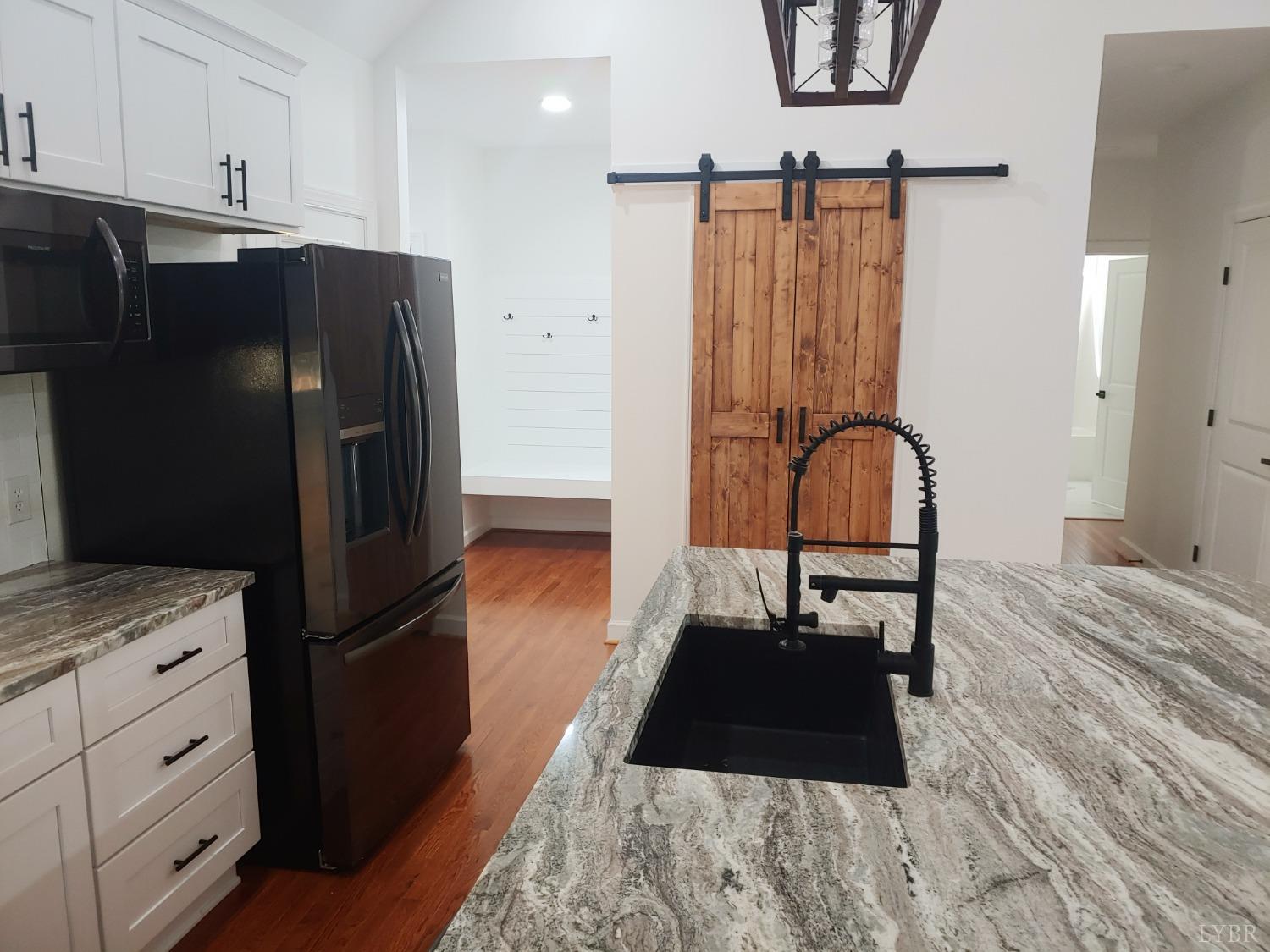6230 Charlemont Road Goode, VA 24556 - Photo 30 of 99 a kitchen with a refrigerator a stove and a cabinets