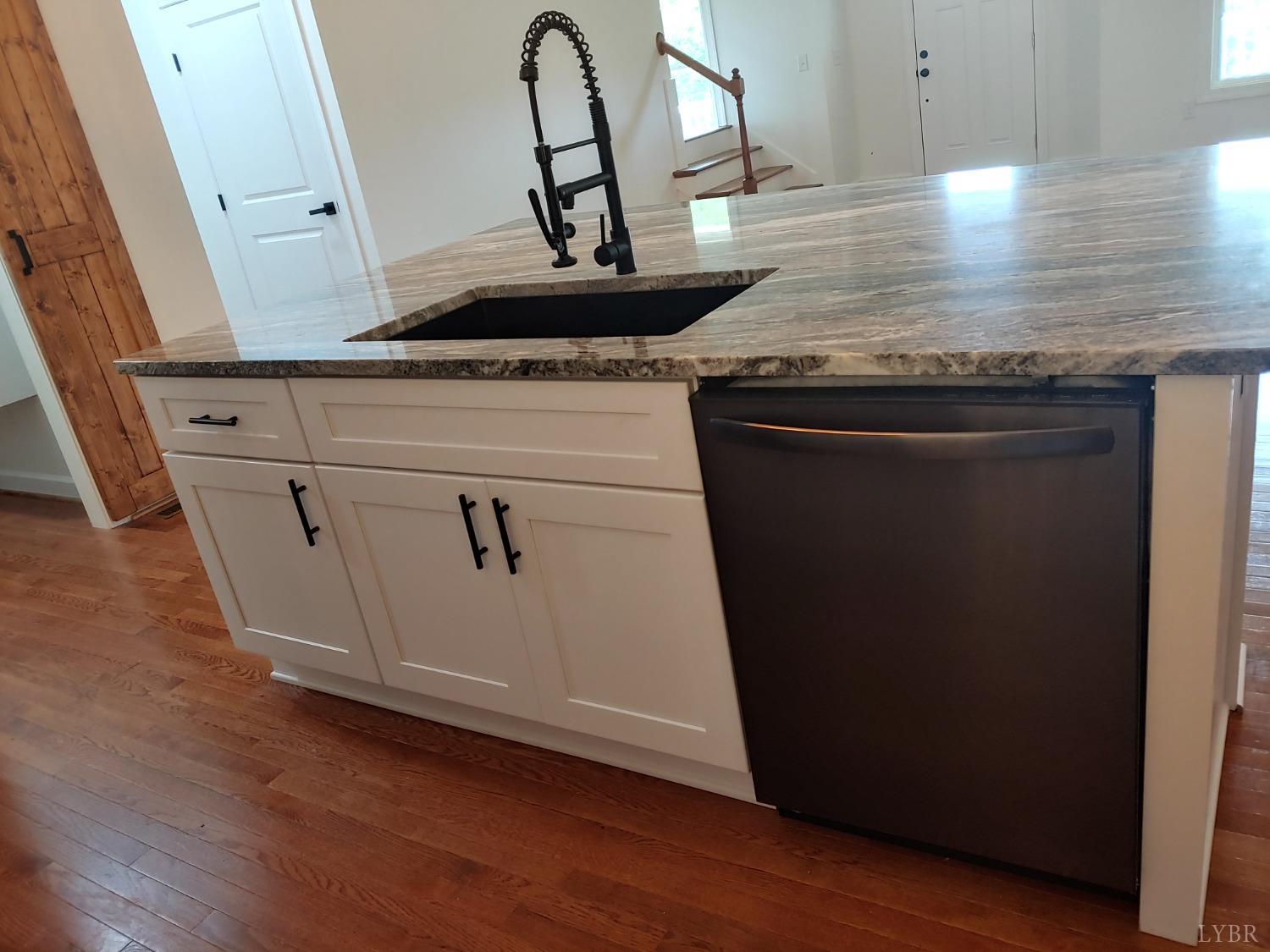 6230 Charlemont Road Goode, VA 24556 - Photo 37 of 99 a view of a kitchen with granite countertop white cabinets and wooden floor