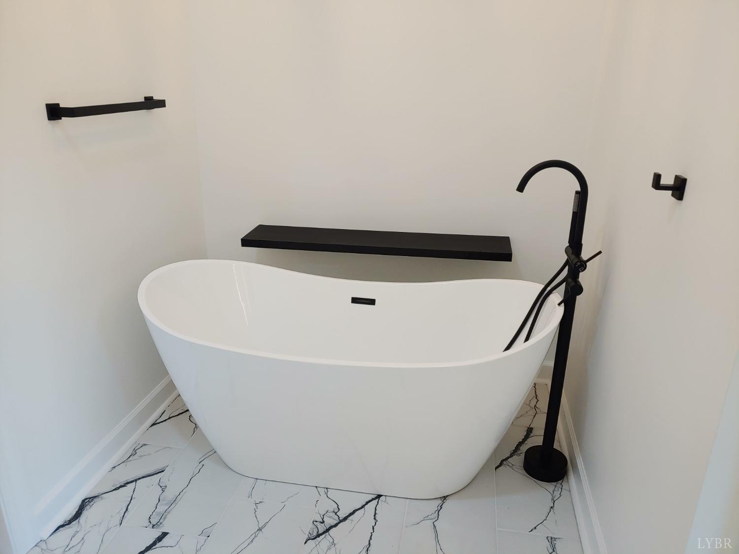 6230 Charlemont Road Goode, VA 24556 - Photo 43 of 99 a white bath tub sitting in a bathroom