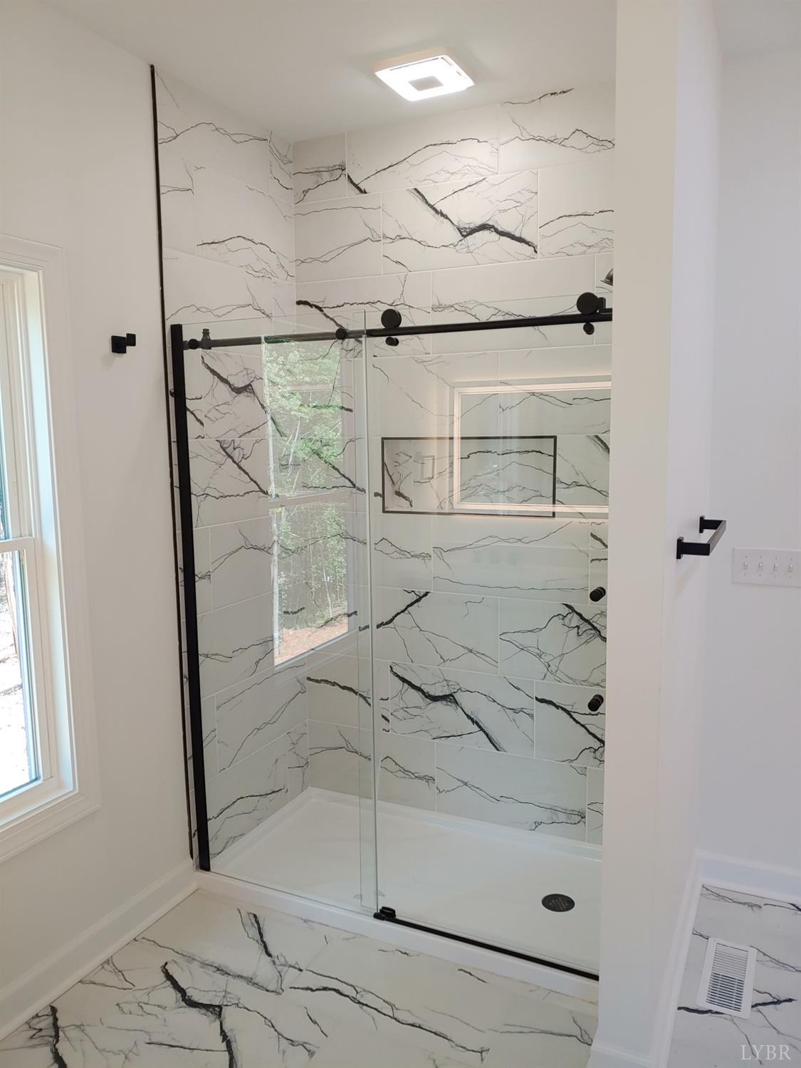 6230 Charlemont Road Goode, VA 24556 - Photo 47 of 99 a bathroom with a glass shower door