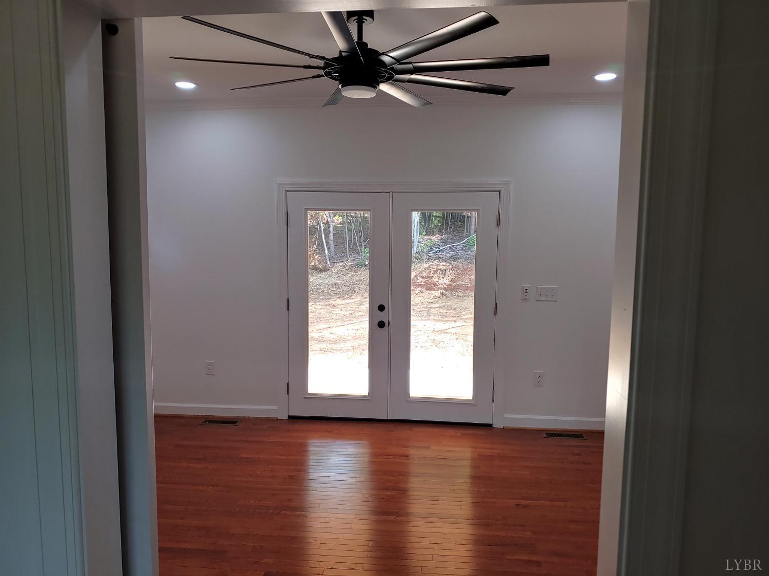 6230 Charlemont Road Goode, VA 24556 - Photo 55 of 99 a view of empty room with wooden floor and fan