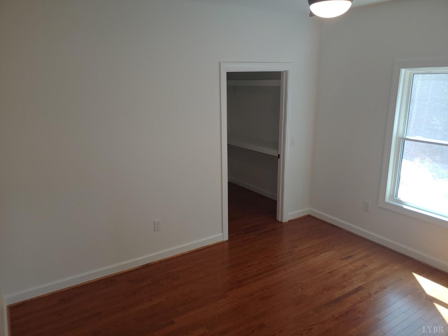 6230 Charlemont Road Goode, VA 24556 - Photo 62 of 99 an empty room with wooden floor and windows