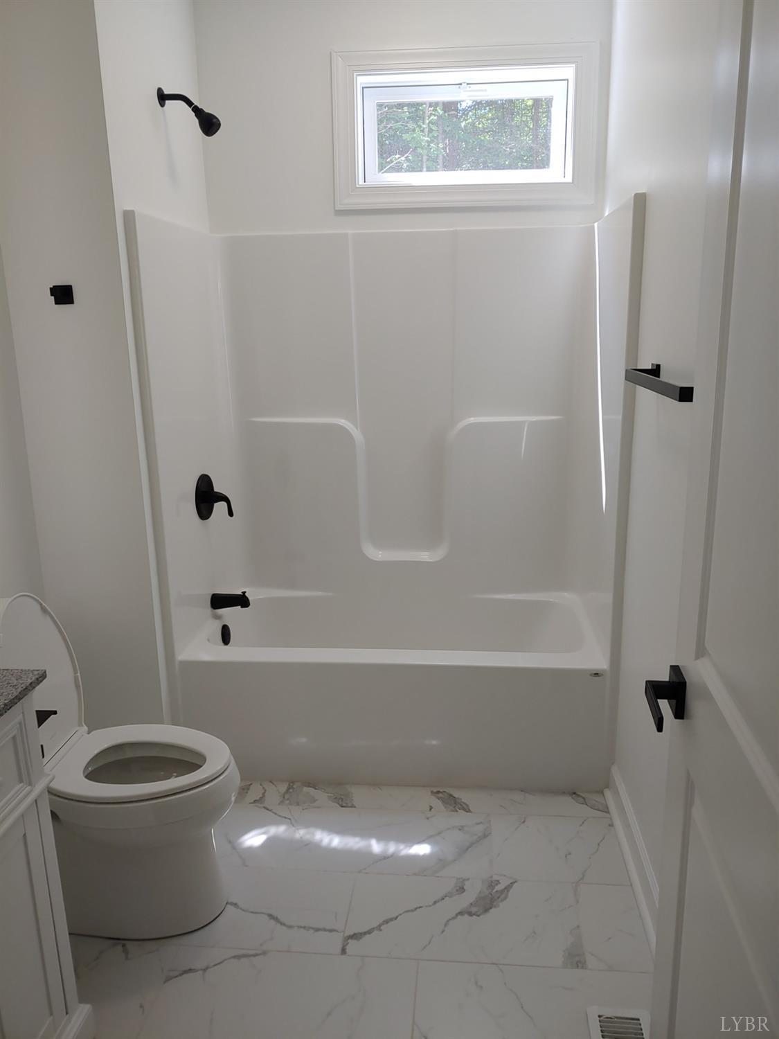 6230 Charlemont Road Goode, VA 24556 - Photo 66 of 99 a white toilet sitting next to a bath tub