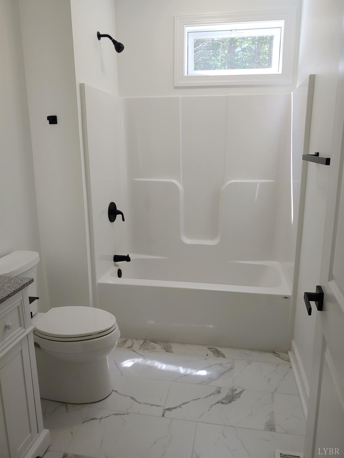 6230 Charlemont Road Goode, VA 24556 - Photo 67 of 99 a white toilet sitting next to a bath tub