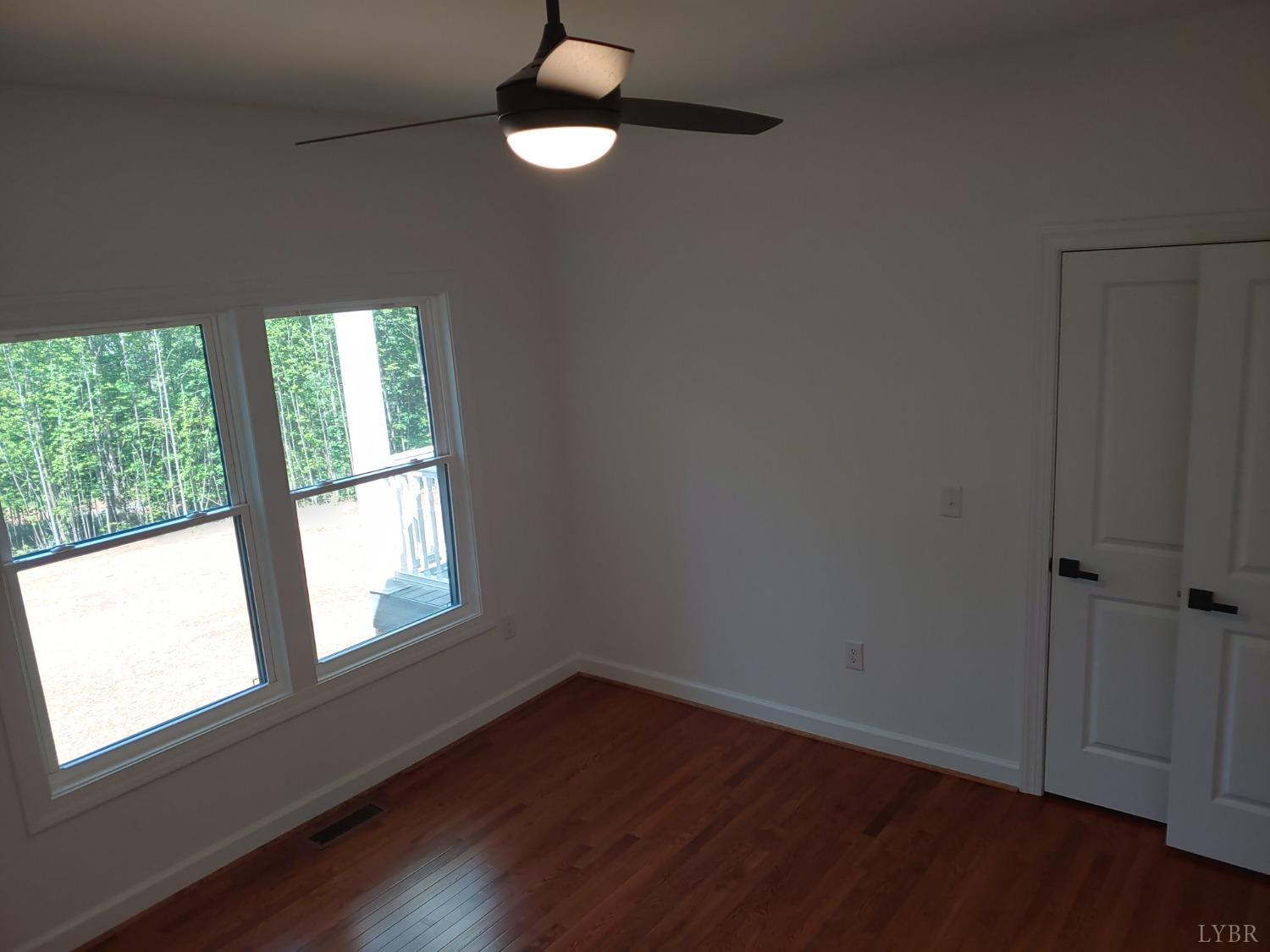 6230 Charlemont Road Goode, VA 24556 - Photo 72 of 99 an empty room with wooden floor and windows