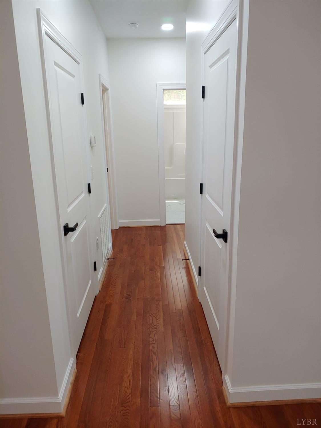 6230 Charlemont Road Goode, VA 24556 - Photo 76 of 99 a view of a hallway with wooden floor and staircase