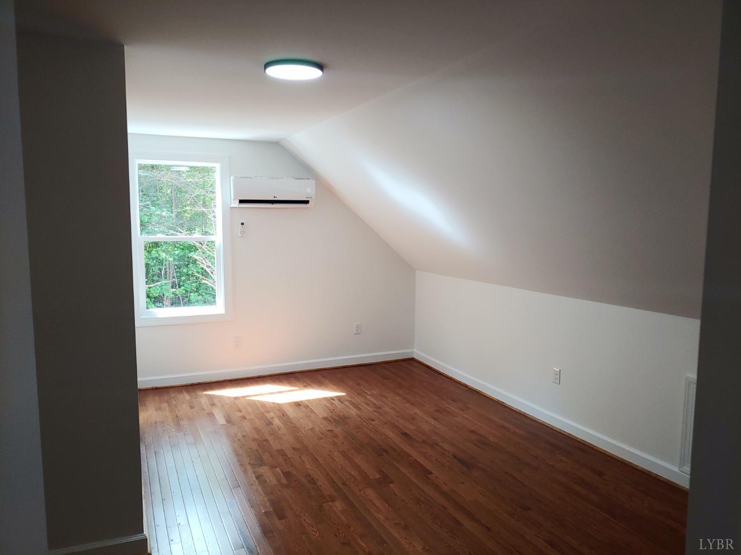 6230 Charlemont Road Goode, VA 24556 - Photo 79 of 99 an empty room with wooden floor and windows