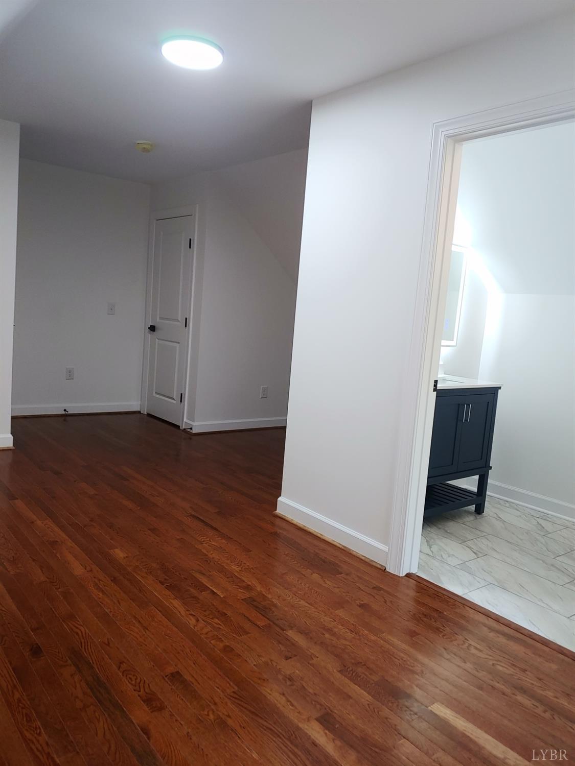 6230 Charlemont Road Goode, VA 24556 - Photo 83 of 99 an empty room with wooden floor and chair
