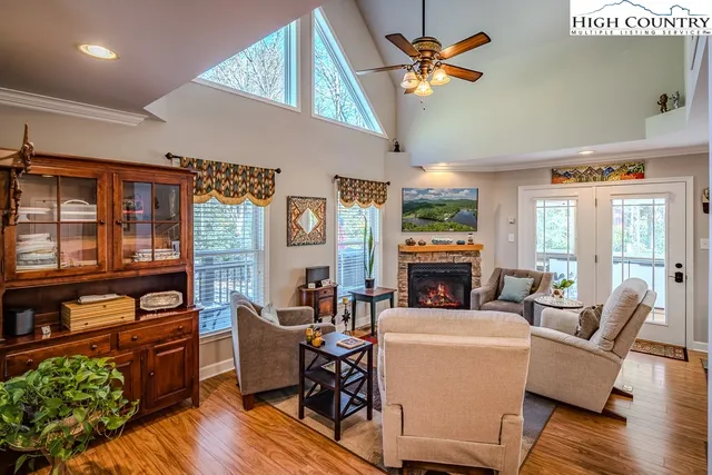 a living room with fireplace furniture and a wooden floor