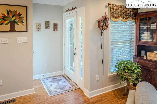 a view of an entryway with wooden floor
