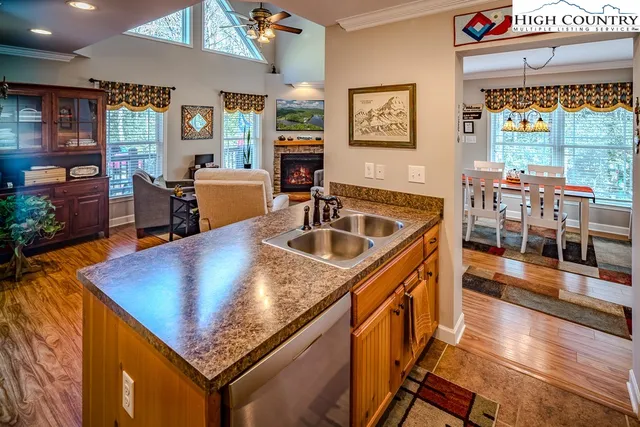 a kitchen with stainless steel appliances granite countertop sink stove top oven and cabinets