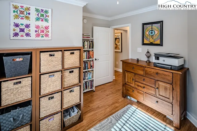 a view of a workspace with furniture and paintings on the wall