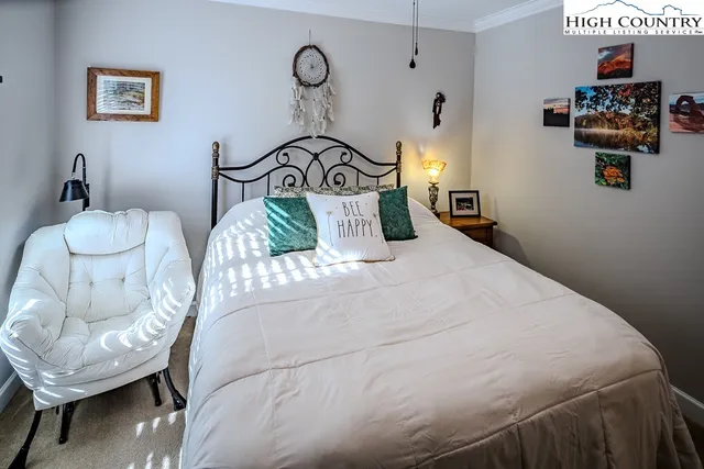 a bedroom with a bed and a chair