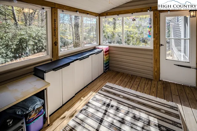 a view of a room with wooden floor and windows