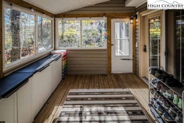 a view of a room with wooden floor and windows