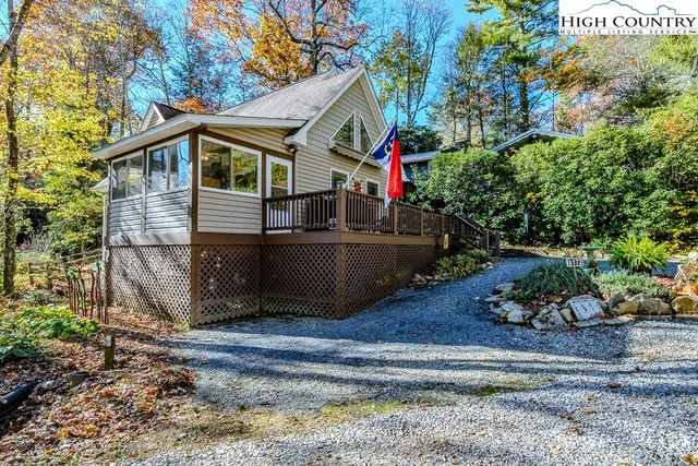 a front view of a house with a yard and potted plants