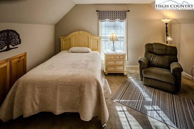 a bedroom with a bed couch and a dresser