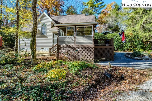 a view of a house with a yard and potted plants