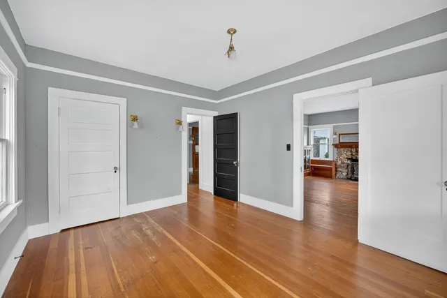 a view of a house with a yard and large tree