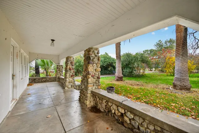 a view of empty room with wooden floor and floor to ceiling window