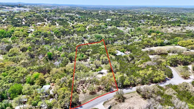 an aerial view of a houses with a yard