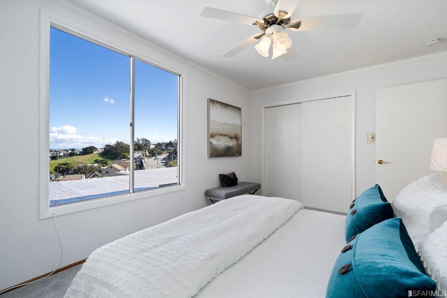 385 Corbett Avenue San Francisco, CA 94114 - Photo 35 of 72 a bedroom with a large bed and a chandelier