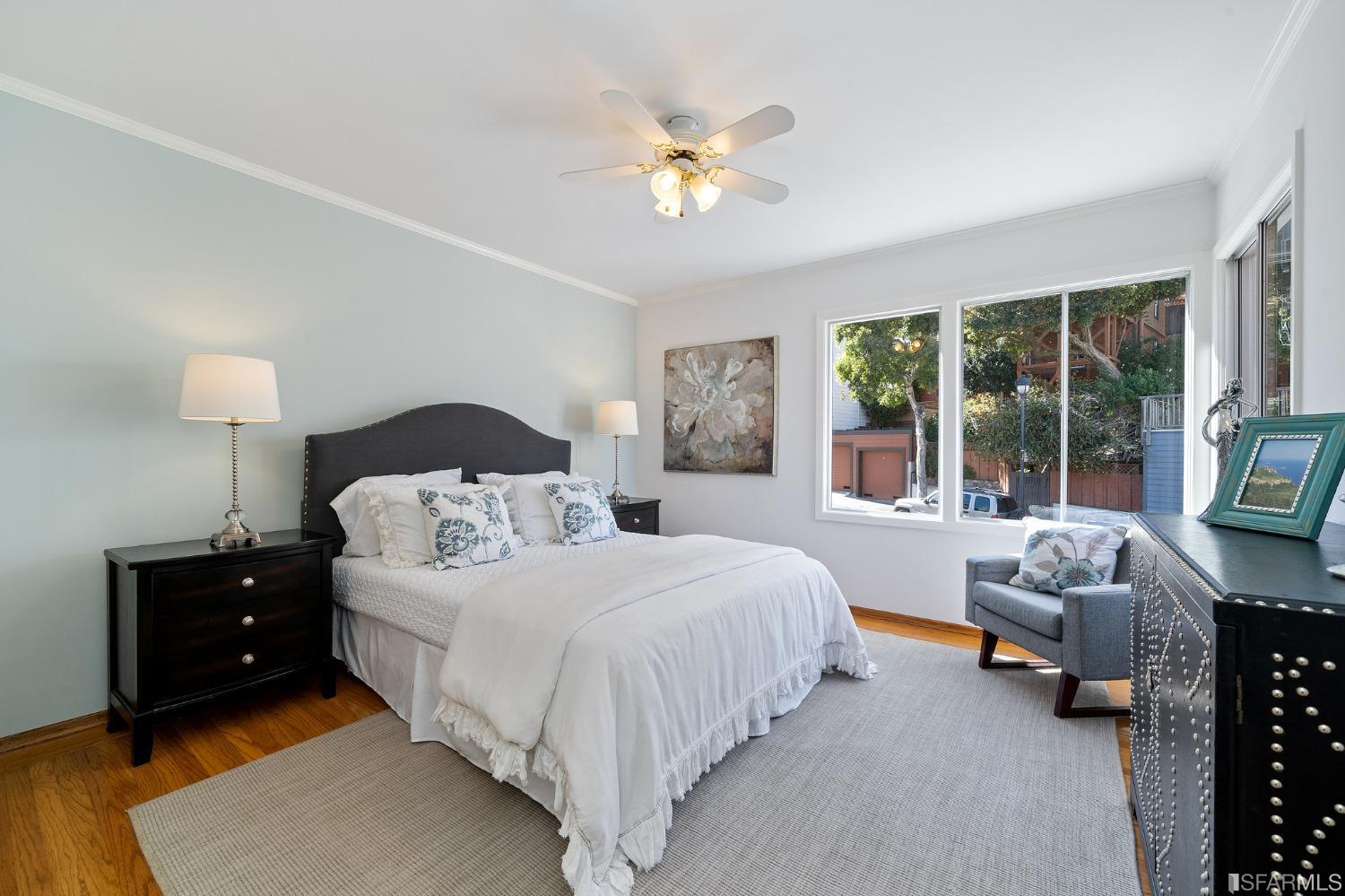 385 Corbett Avenue San Francisco, CA 94114 - Photo 38 of 72 a spacious bedroom with a bed and a couch next to a window