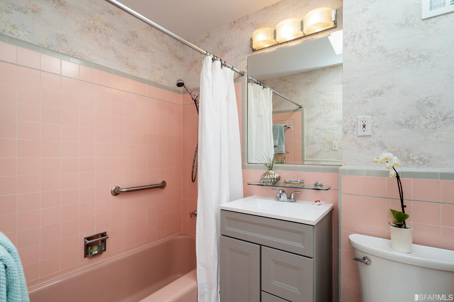 385 Corbett Avenue San Francisco, CA 94114 - Photo 44 of 72 a bathroom with a sink a mirror a toilet and shower