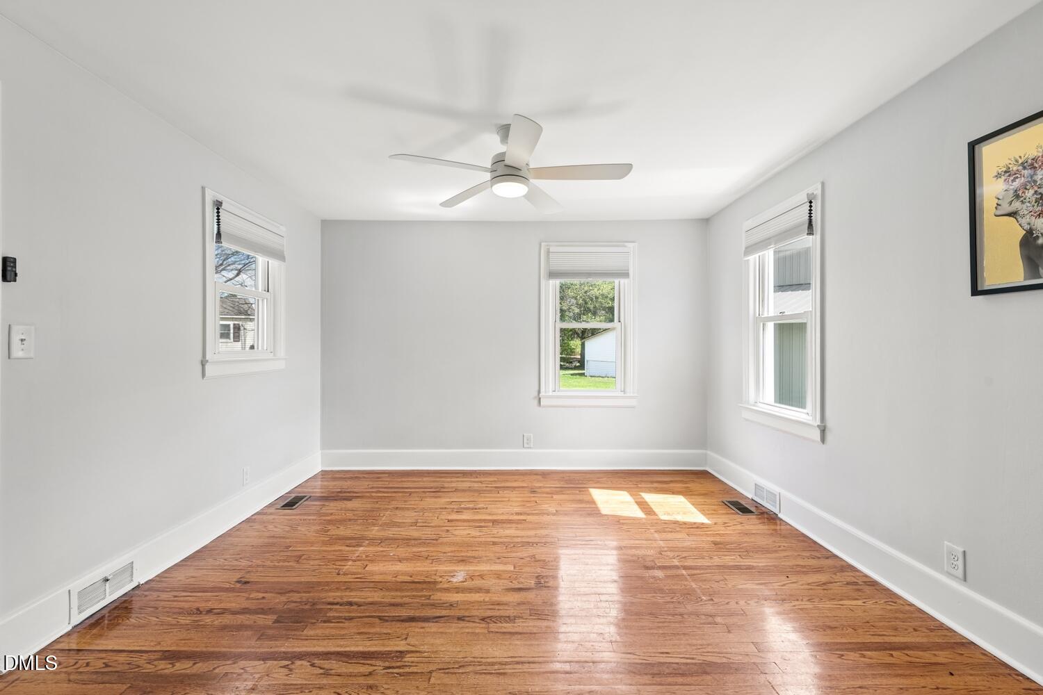 414 South Maple Street Graham, NC 27253 - Photo 13 of 42 a view of empty room with wooden floor and fan