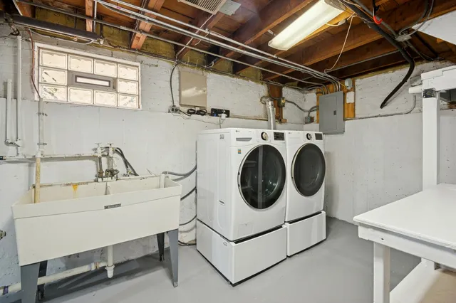 a backyard of a house with plants and large tree