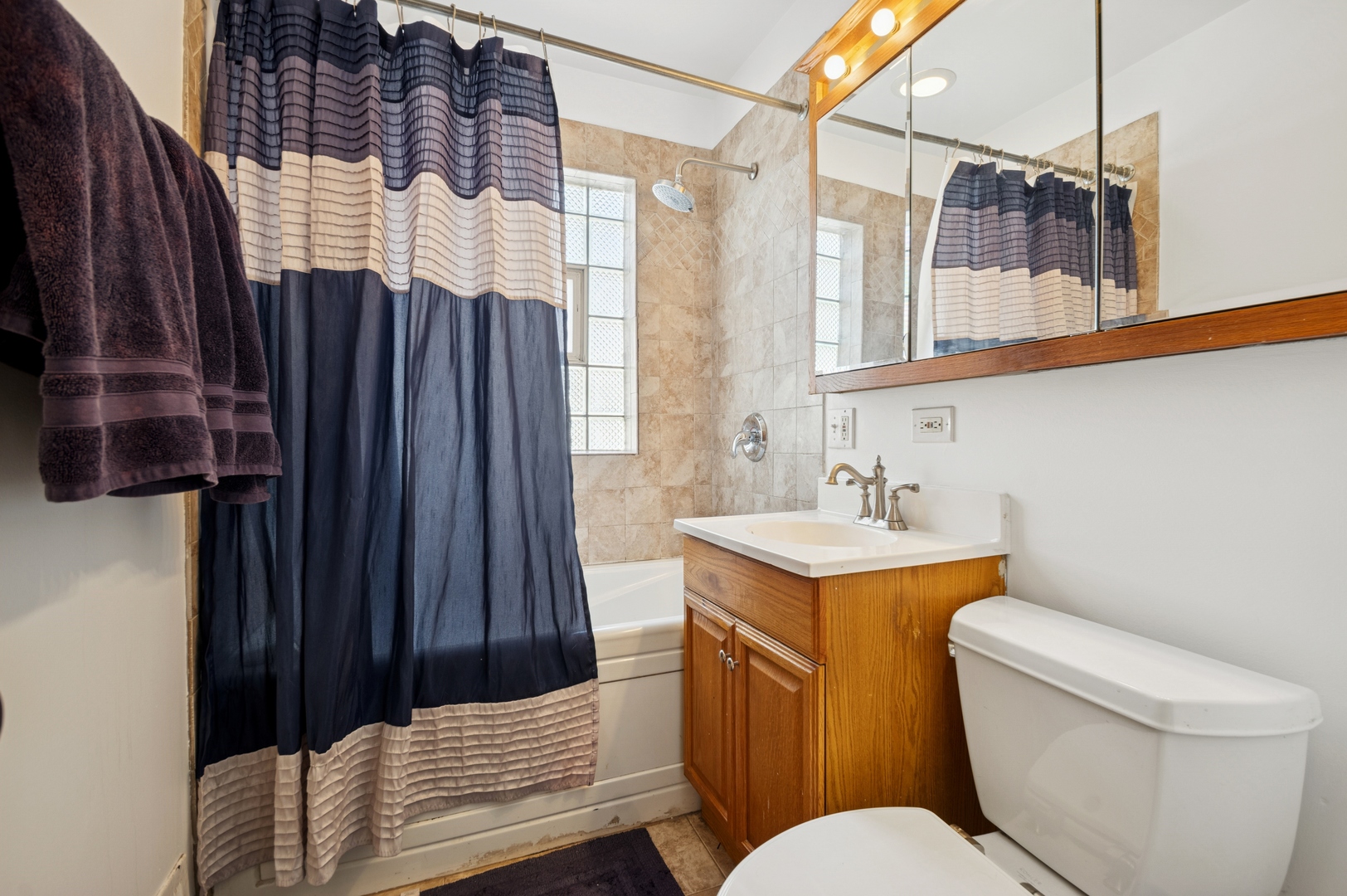 4631 North Lawler Avenue Chicago, IL 60630 - Photo 22 of 34 a bathroom with a sink a toilet and shower