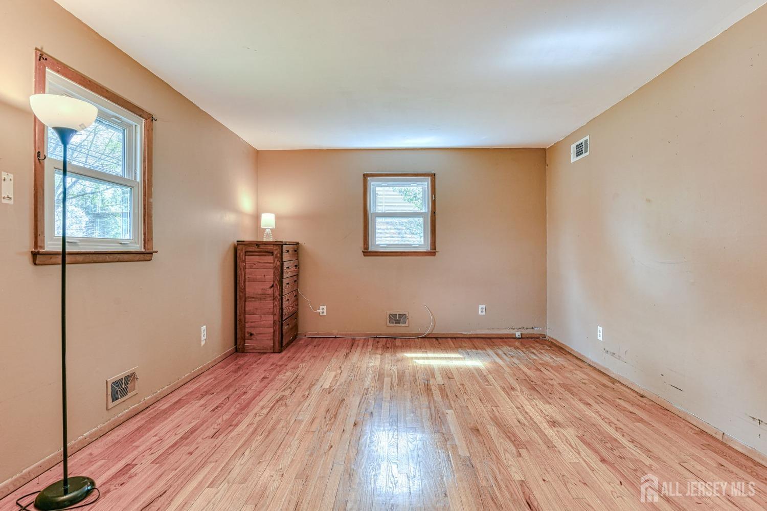 13 Howard Street Milltown, NJ 08850 - Photo 13 of 33 a view of an empty room with wooden floor and a window