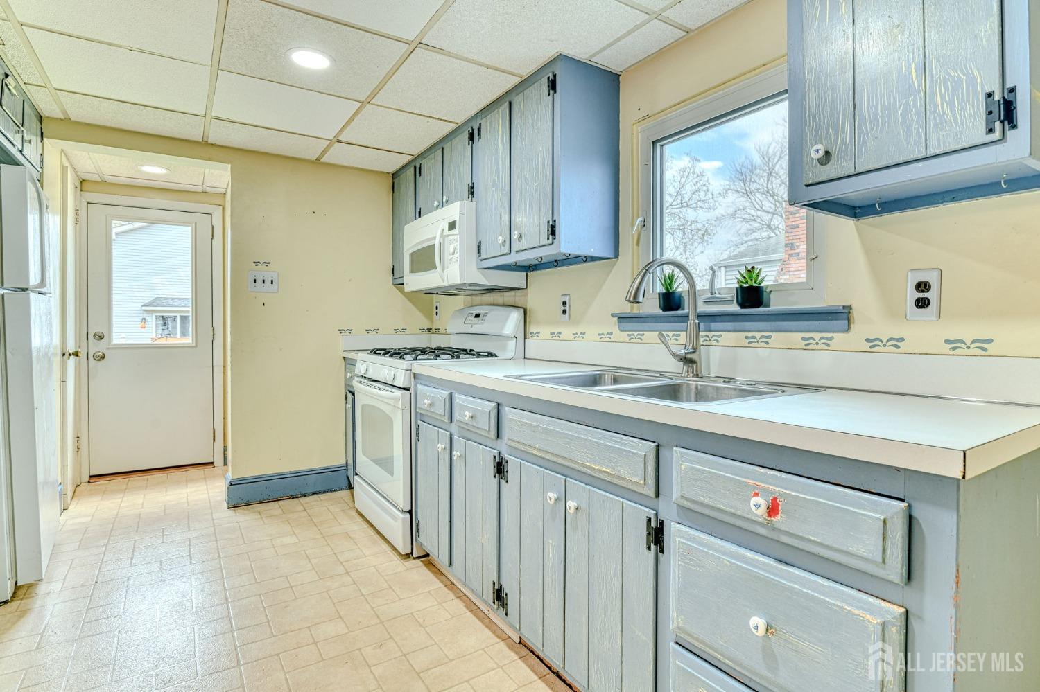 13 Howard Street Milltown, NJ 08850 - Photo 15 of 33 a kitchen with stainless steel appliances granite countertop a sink and a stove