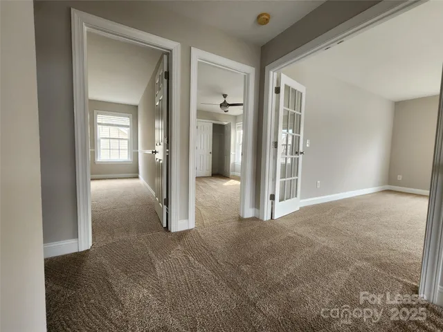 an empty room with windows and entrance