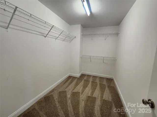 a bathroom with a granite countertop sink a mirror and a shower