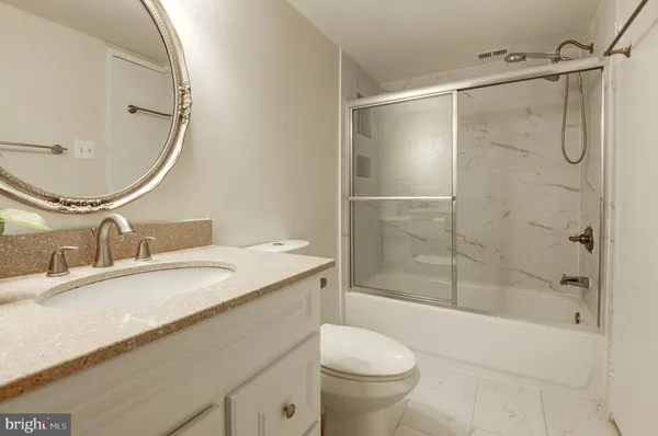 a white toilet sitting next to a bathroom sink