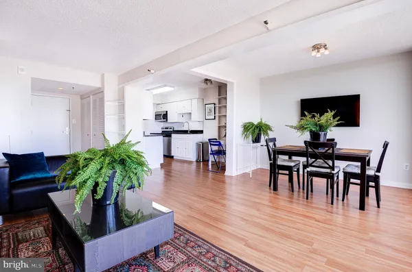 a living room with furniture and a wooden floor