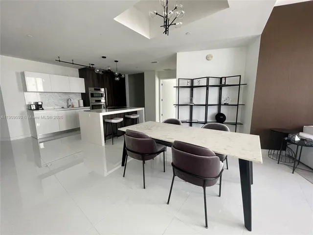 a view of a dining room with furniture and window
