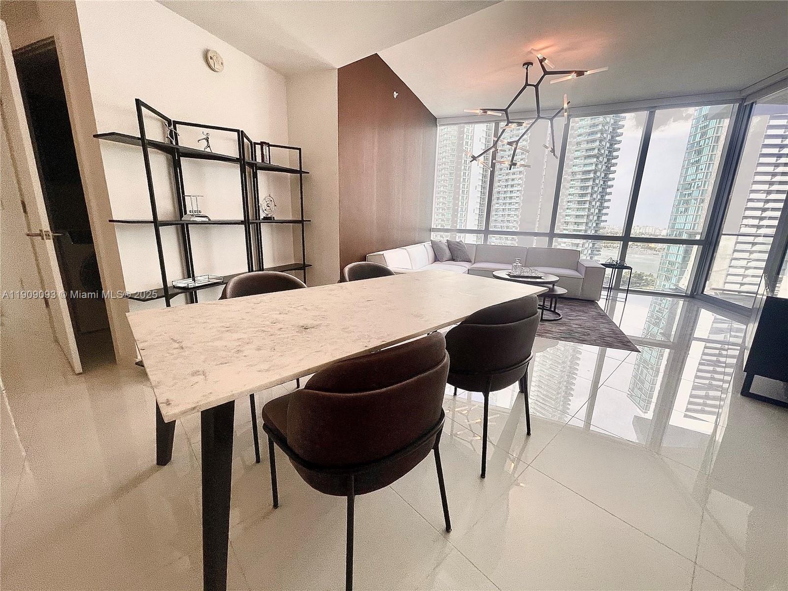 851 Northeast 1st Avenue, Unit 2403 Miami, FL 33132 - Photo 13 of 25 a view of a dining room with furniture and window
