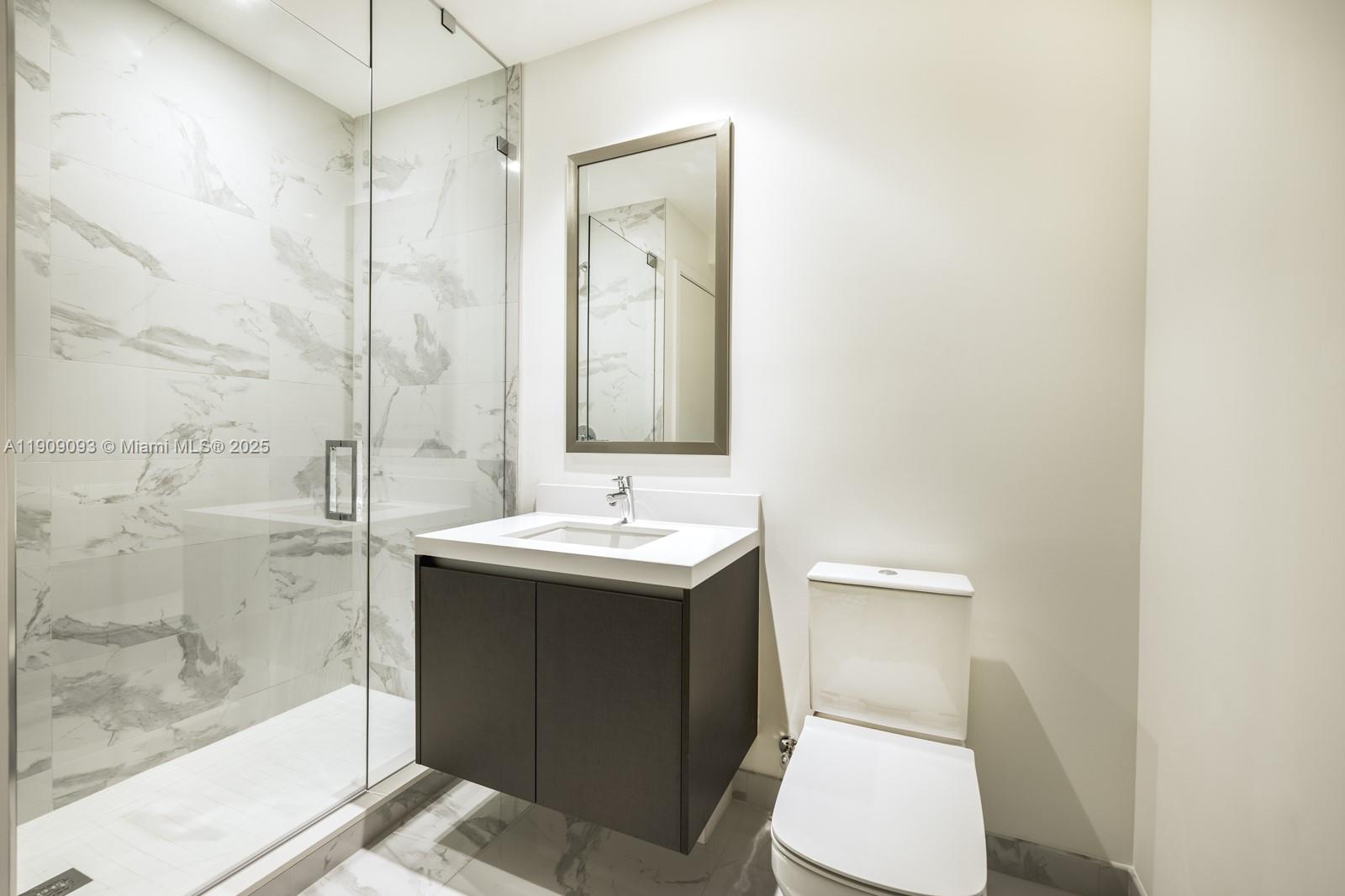 851 Northeast 1st Avenue, Unit 2403 Miami, FL 33132 - Photo 14 of 25 a bathroom with a sink toilet and shower