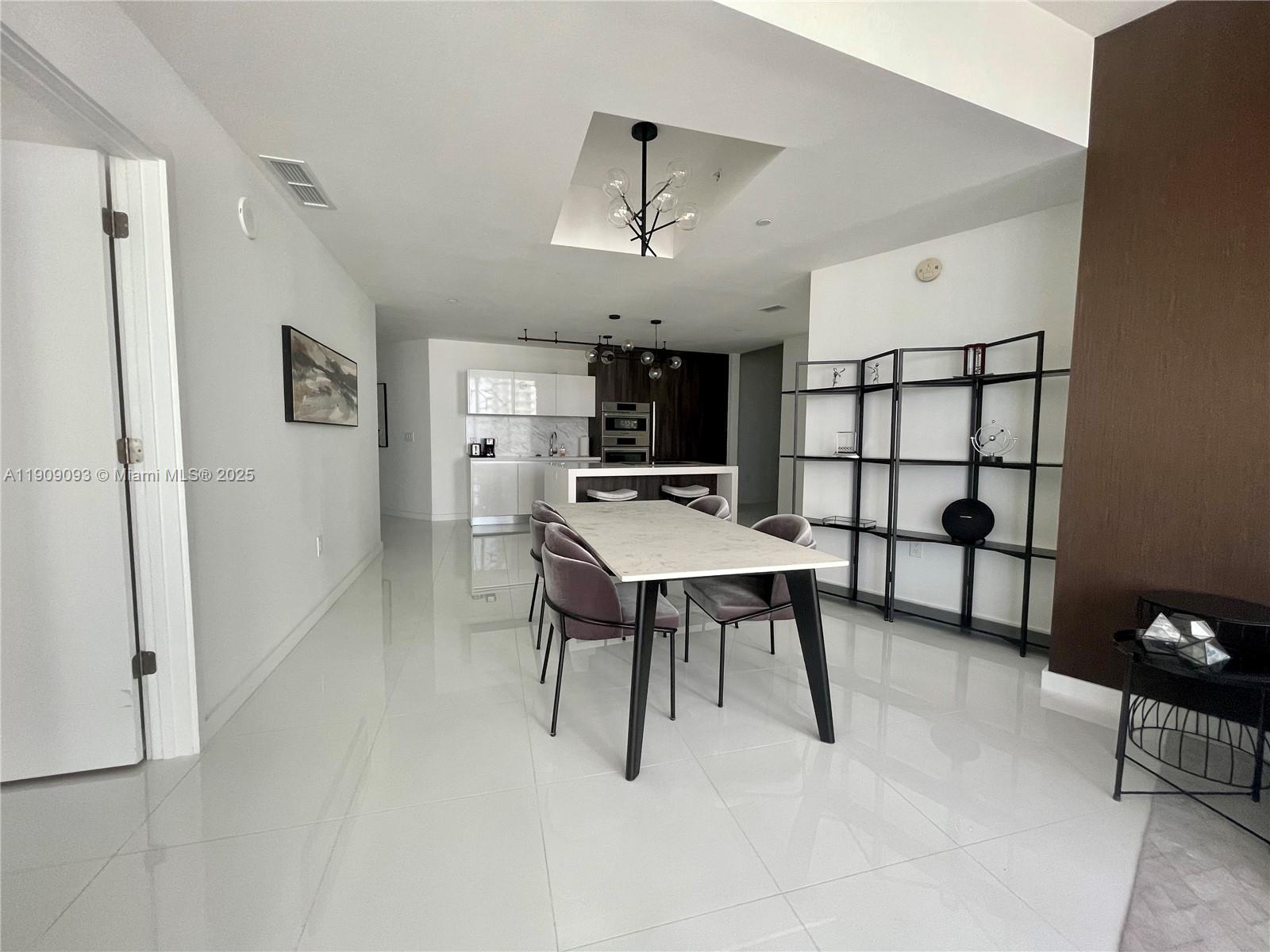 851 Northeast 1st Avenue, Unit 2403 Miami, FL 33132 - Photo 15 of 25 a view of a dining room with furniture
