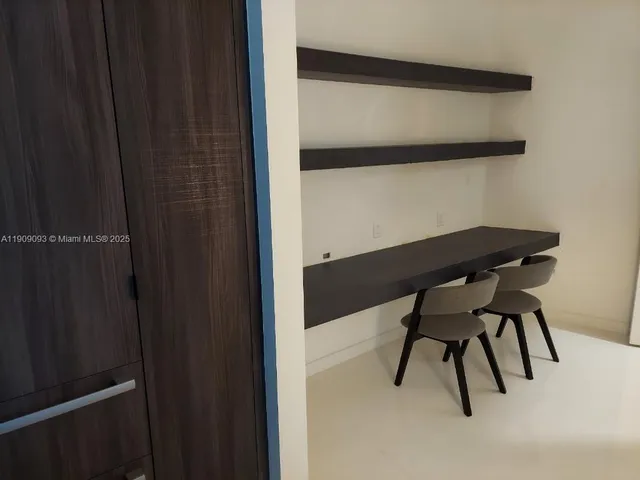 a kitchen with granite countertop a sink cabinets and window