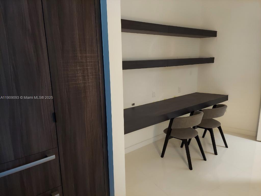 851 Northeast 1st Avenue, Unit 2403 Miami, FL 33132 - Photo 17 of 25 a view of table and chair with wooden floor