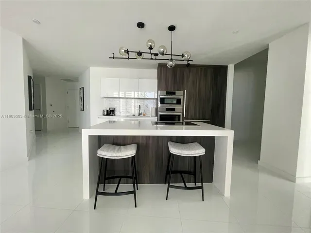 a kitchen with cabinets and stainless steel appliances