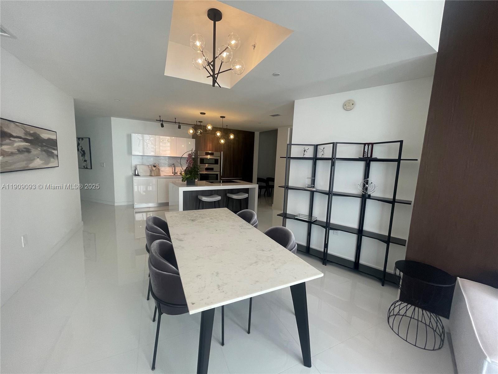 851 Northeast 1st Avenue, Unit 2403 Miami, FL 33132 - Photo 5 of 25 a view of a dining room with furniture