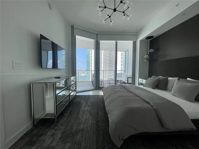 a spacious bedroom with a bed and a table in it