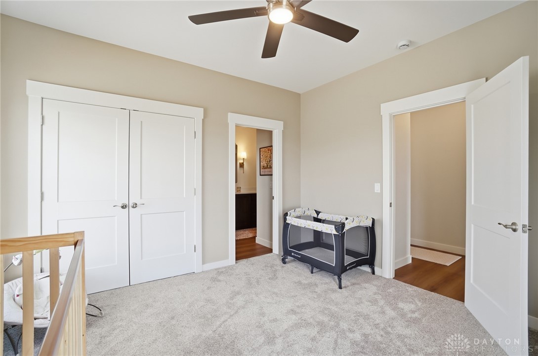 9364 Kenrick Road Dayton, OH 45458 - Photo 29 of 62 This cozy bedroom features plush carpeting and a modern ceiling fan, creating a comfortable living space.